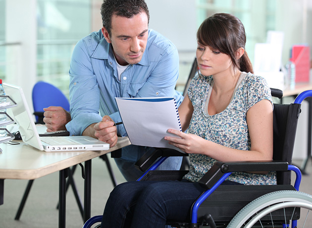 ss-young-woman-in-wheelchair-working-with-a-male-colleague-81311647_630x460